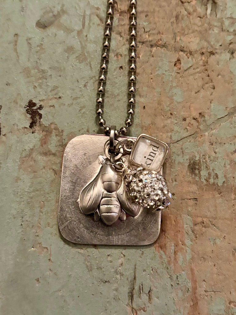 square embossed “bee kind” pendant