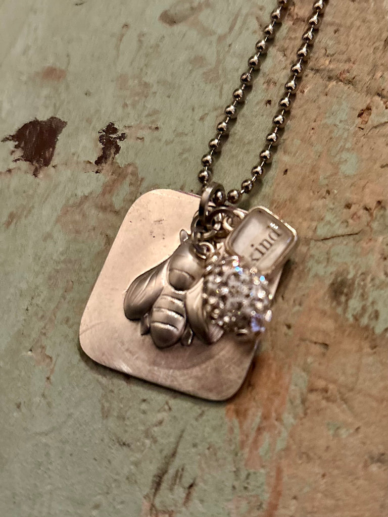 square embossed “bee kind” pendant