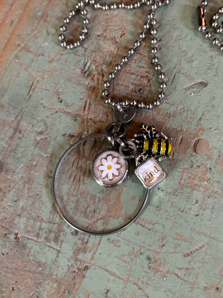 “vintage optical pendant “bee kind”